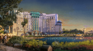 Gran Destino Tower glows with vibrant lights and lush greenery at sunset, a stunning landmark at Disney’s Coronado Springs Resort.
