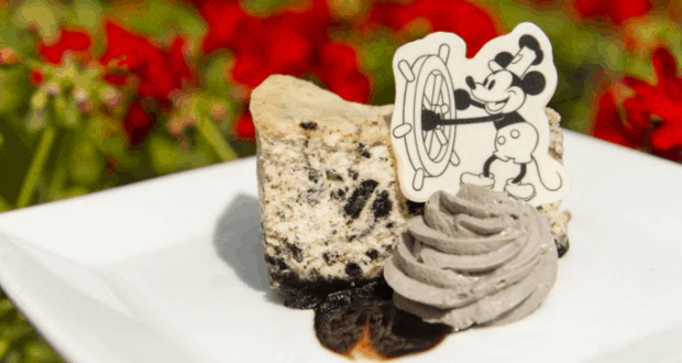 Cookies and cream cheesecake topped with grey whipped cream and a Mickey Mouse decoration, served at Walt Disney World.