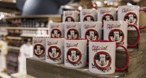 Official Mouseketeer mugs with Mickey Mouse are lined up on Disney Springs shelves, ready for magical birthday celebrations.