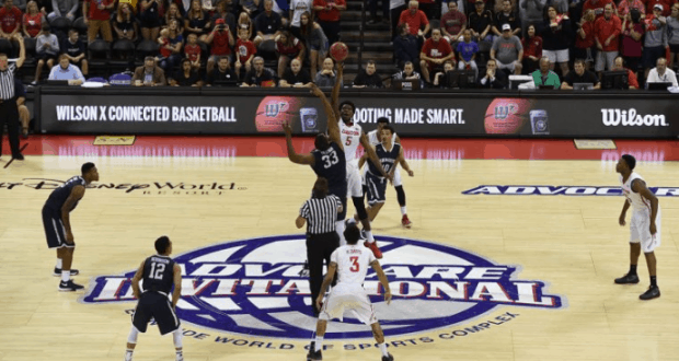 College basketball teams leap for the tip-off at center court during the AdvoCare Invitational at Walt Disney World Resort.