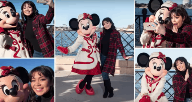 Minnie Mouse joins a guest for fun selfies by the water at Walt Disney World on a beautiful sunny day.