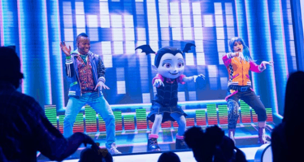 Three Disney Junior stars, including Vampirina, light up the vibrant stage with energetic dance moves at Walt Disney World.