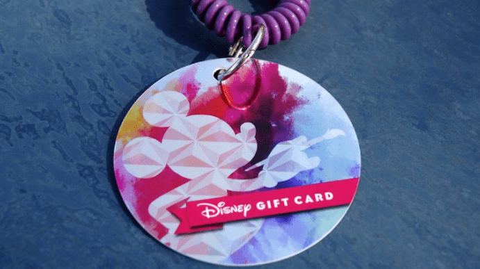 Colorful Mickey Mouse Disney Gift Card on a purple coil wristband, perfect for Epcot International Festival of the Arts at Disney World.