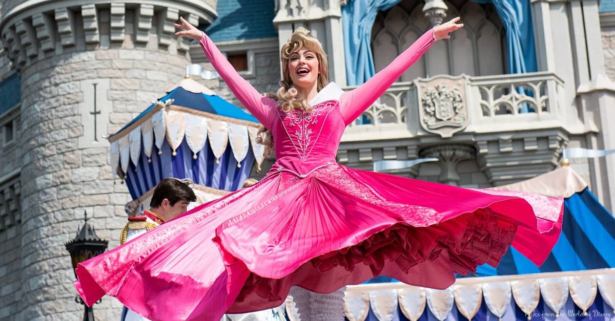 Sleeping Beauty twirls joyfully in front of Cinderella Castle, celebrating the enchantment of Disney Princess Experiences at Disney World.