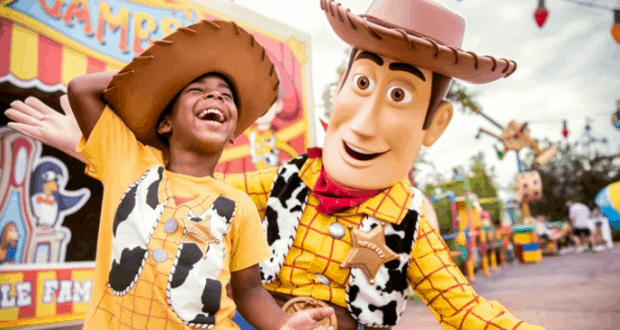 Woody and a young fan, both in cowboy hats, share a magical moment together at Walt Disney World.