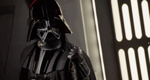 Darth Vader in iconic black armor greets fans inside Epcot at Galactic Gathering, raising a gloved hand for a classic photo op.