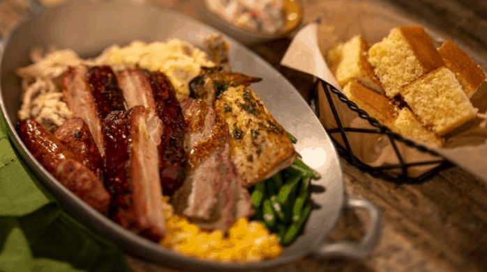 Whispering Canyon Cafe skillet: barbecue meats, green beans, corn, and cornbread—a must-try for hungry Disney fans.
