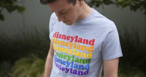 The Rainbow Disney Collection’s gray tee showcases "disneyland" in vibrant rainbow hues—perfect for park fans and collectors.