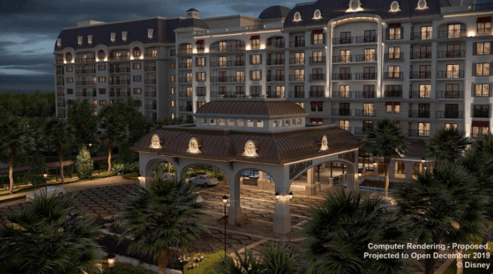 Disney’s Riviera Resort shines at night with its grand entrance, glowing arches, balconies, and palm trees at Walt Disney World.