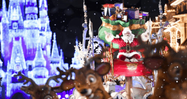 Santa Claus waves from his sleigh with reindeer in front of Cinderella Castle, glowing with holiday lights at Walt Disney World.