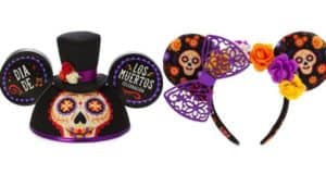 Día de los Muertos Mickey ears at Disney World: one with a festive hat, the other with flowers, skulls, and a purple bow.