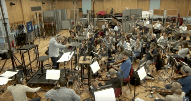 The Epcot Forever orchestra rehearses in the studio, led by their conductor, to create the magic for Walt Disney World's nighttime show.