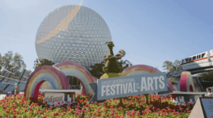 Vibrant EPCOT Festival of the Arts display with Spaceship Earth and the Disney monorail at Walt Disney World, 2020.
