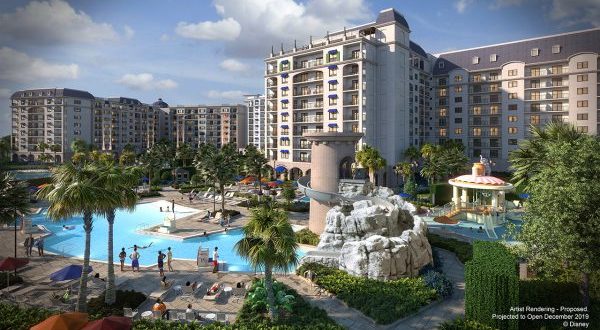 Riviera Resort features tall towers, a sunny pool with waterslide, palm trees, and sunbathers—just steps from Disney World.