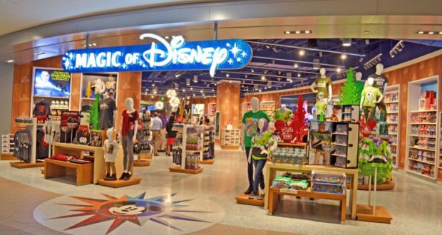 Step into the Disney Store at Orlando Airport, greeted by iconic characters, park merch, and a glowing "Magic of Disney" sign.