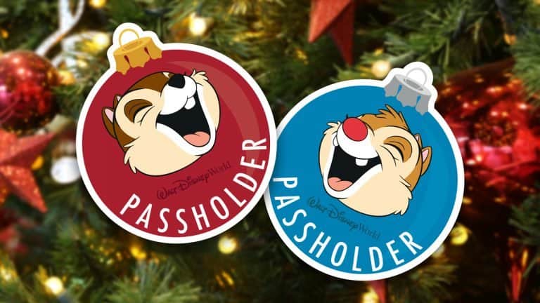 Chip and Dale Annual Passholder ornaments shine on a Disney World Christmas tree, aglow with festive lights and holiday magic.