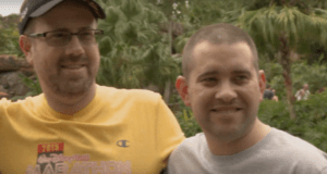 Two happy runners celebrate their Disney Wine & Dine Half Marathon finish, surrounded by magical greenery in the park.