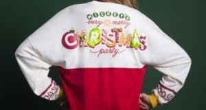 Festive Mickey's Very Merry Christmas Party shirt, iconic Disney World holiday merchandise worn by a park guest.