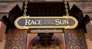 Race Against The Sun" sign with intricate patterns and gold trim stands above an entrance in Epcot’s Morocco Pavilion.