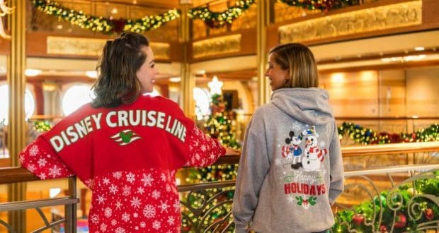 Guests aboard a Disney Cruise Line ship sport exclusive holiday sweaters, smiling and showing off festive new merchandise.