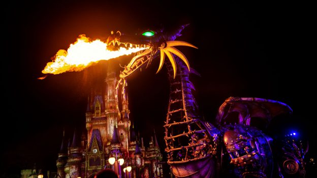 Maleficent’s fire-breathing dragon float lights up Fantasyland at night during Disney Villains After Hours at Magic Kingdom.