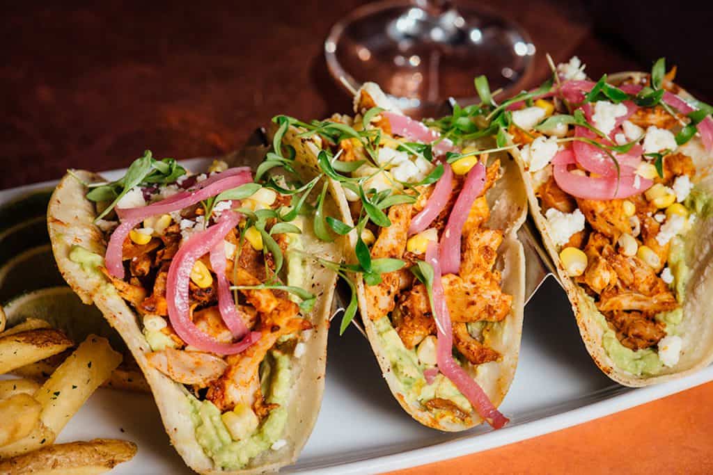 Tacos served on a plate at Disney Springs, ready to enjoy during your day of eats and entertainment at the resort.