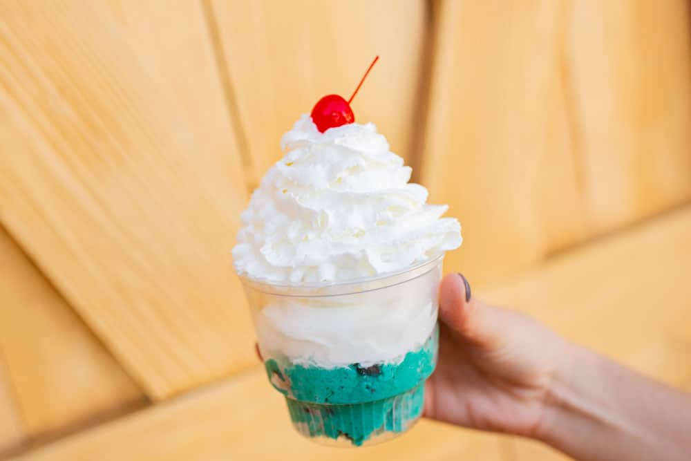 Blue soft serve with whipped cream and a cherry, just like guests enjoy at Disney’s Typhoon Lagoon—a signature sundae delight!.