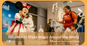 Minnie Mouse and Disney VoluntEARS bring holiday cheer to a hospital, delighting guests near sparkling white Christmas trees.