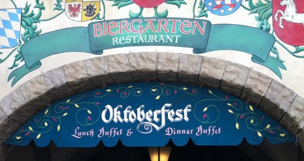 Biergarten Restaurant entrance at Epcot, with Oktoberfest buffet sign above a stone archway for lively German-themed dining.