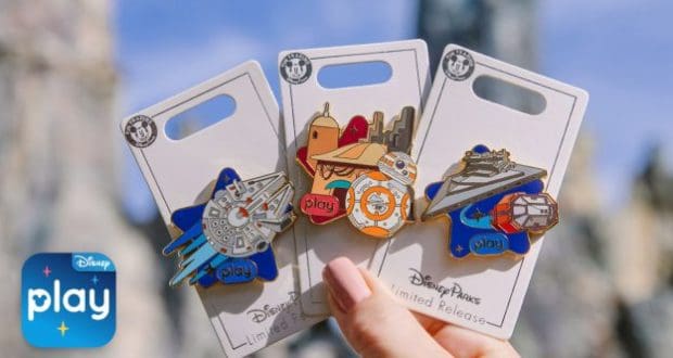 Star Wars achievement pins held up with Galaxy’s Edge in the background, celebrating Datapad milestones at Disney Parks.