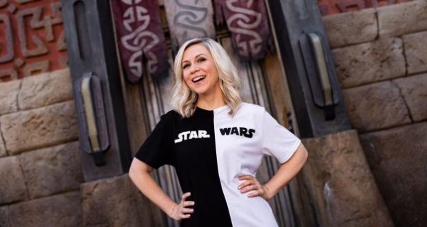 Her Universe Star Wars fan smiling confidently and posing hands-on-hips, ready for a day at Galaxy’s Edge.