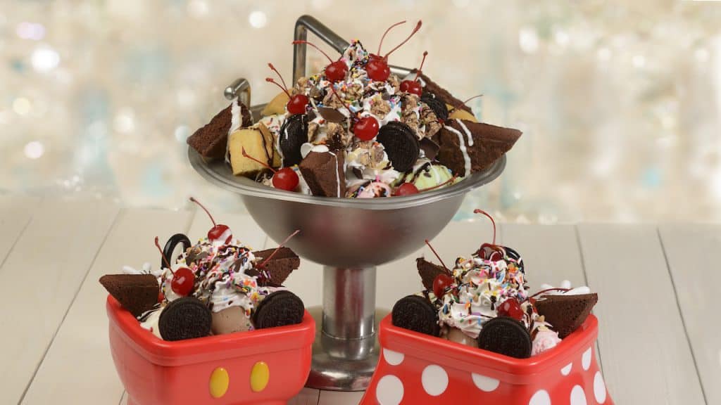 Three Beaches & Cream Soda Shop sundaes topped with brownies, cookies, cherries, and sprinkles on a Disney World table.