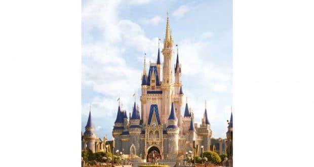 Cinderella Castle dazzles with blue and gold spires, towering over Magic Kingdom beneath a bright, partly cloudy Florida sky.