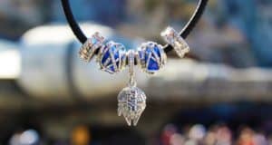 Star Wars necklace with blue and silver beads and a Mandalorian helmet charm, just right for fans exploring Galaxy’s Edge.