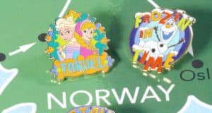 Frozen Adventures by Disney pins pop with color atop a vibrant map marked "NORWAY," capturing the spirit of Disney travel.