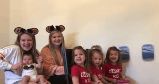 Two women and four kids in Disney gear beam by airplane window wall decor, capturing magical Disney moments for this Texas family.