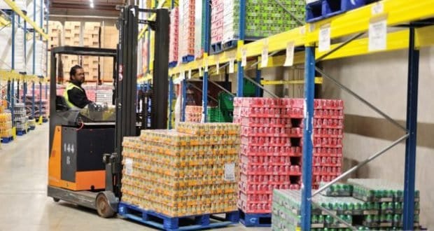 A team member drives a forklift through the park’s backstage warehouse, transporting canned goods to support local community outreach.