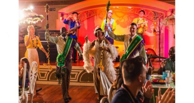 Vibrant performers sing and dance onstage as guests enjoy a New Orleans-inspired celebration aboard Disney Wonder.
