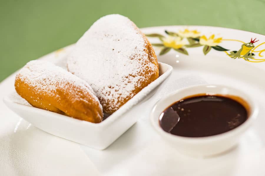 New Orleans–style beignets with powdered sugar and chocolate sauce served on Disney Wonder, a magical Disney Cruise Line treat.