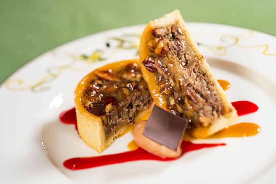 Savor two slices of pecan pie with caramel and red sauce, plus chocolate, just like a sweet treat at a New Orleans Square café.