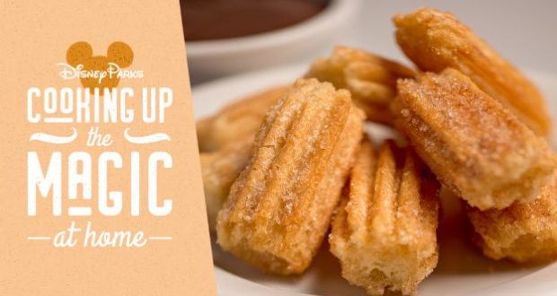 Disney churros dusted with sugar on a plate, alongside "Disney Parks Cooking Up the Magic at Home" text, sharing theme park magic.