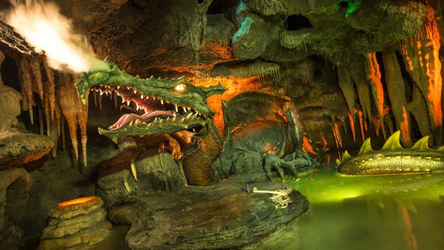 The iconic dragon statue lurking in its dark cavern beneath Disneyland Paris' Sleeping Beauty Castle, inspired by La Tanière du Dragon.