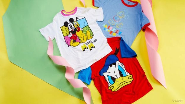 Three vibrant Mickey & Co. tees with Mickey, Donald, and Minnie on yellow—ideal attire for Disney park fans and collectors.