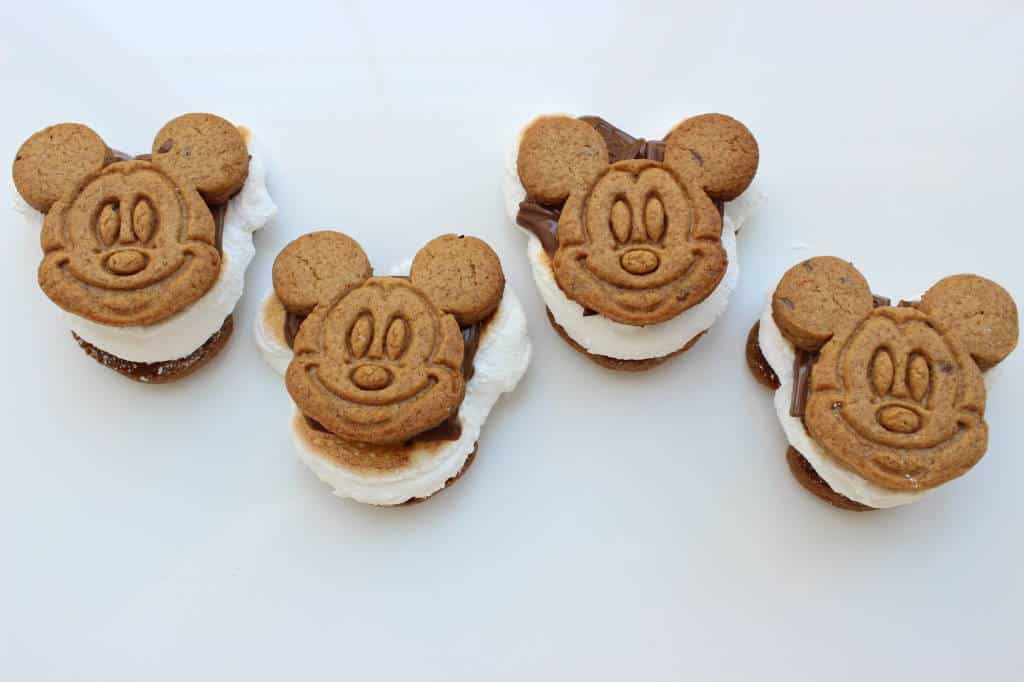 Four Mickey Mouse-shaped s'mores with marshmallow and chocolate—magical Disney snacks perfect for fans planning their next park adventure.