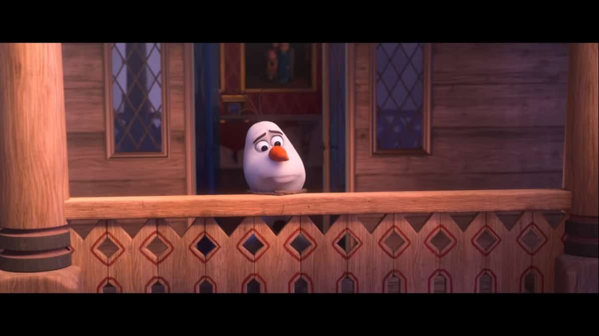 Olaf looks sad on a wooden balcony outside his house, recreating the touching "I Am With You" moment from At Home with Olaf.