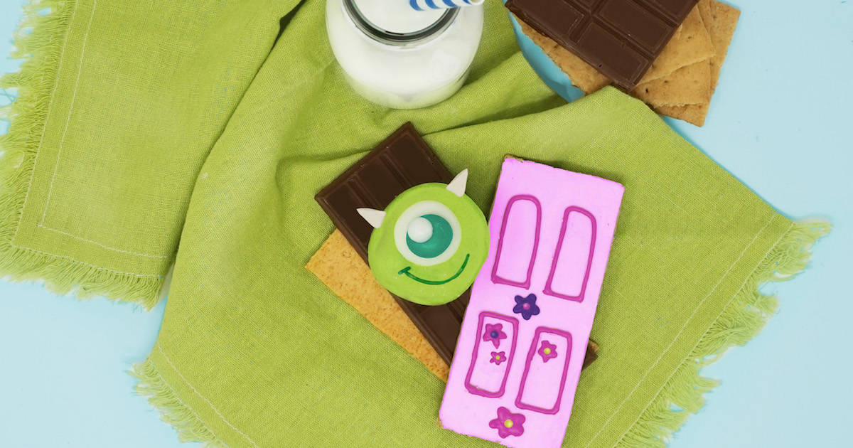 Monsters Inc.-themed s’mores with milk, chocolate, graham crackers, and decorated cookies—a Disney parks dessert delight.