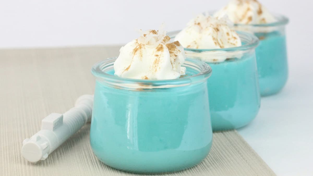 Blue Milk Pudding served in Star Wars: Galaxy’s Edge—three glass jars with whipped cream and cinnamon, ready for fans.