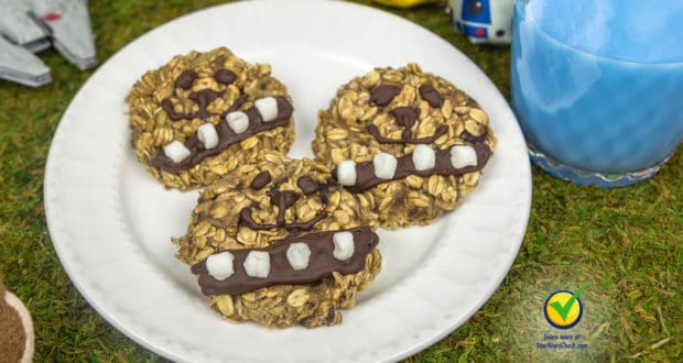 Chewbacca oatmeal cookies await on a Star Wars-themed plate beside a glass of iconic Blue Milk at Galaxy’s Edge.
