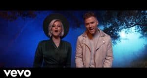 Guests enjoy a live duet of "Into the Unknown" at night, reminiscent of DCappella’s energy in Disney entertainment style.