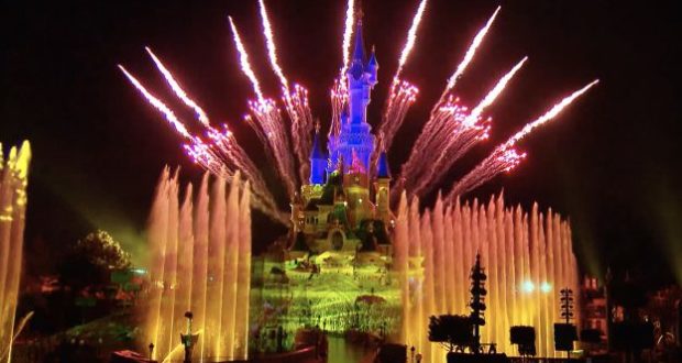 Disney Illuminations lights up Sleeping Beauty Castle in Paris with dazzling fireworks and fountains for a breathtaking nighttime show.